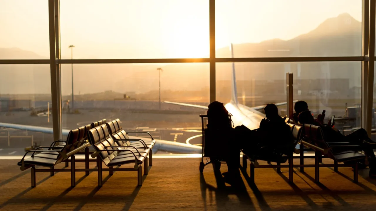 passenger sitting in a lobby airport waiting for flight in