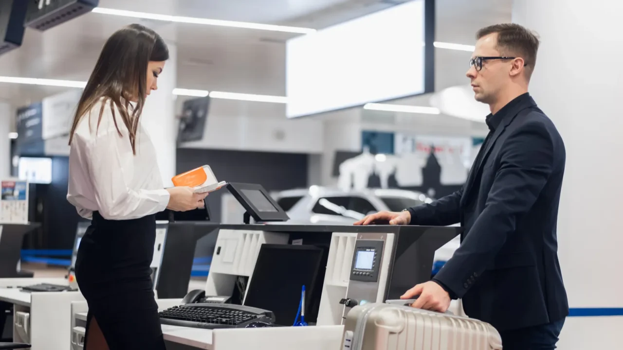 passenger weighing luggage at airport check in