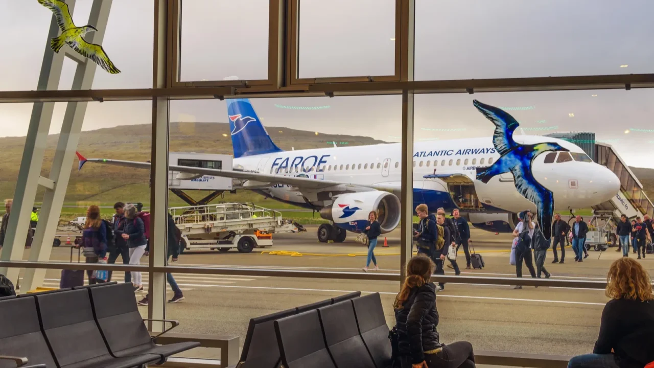 passengers disembark from airplane at the faroe islands airport