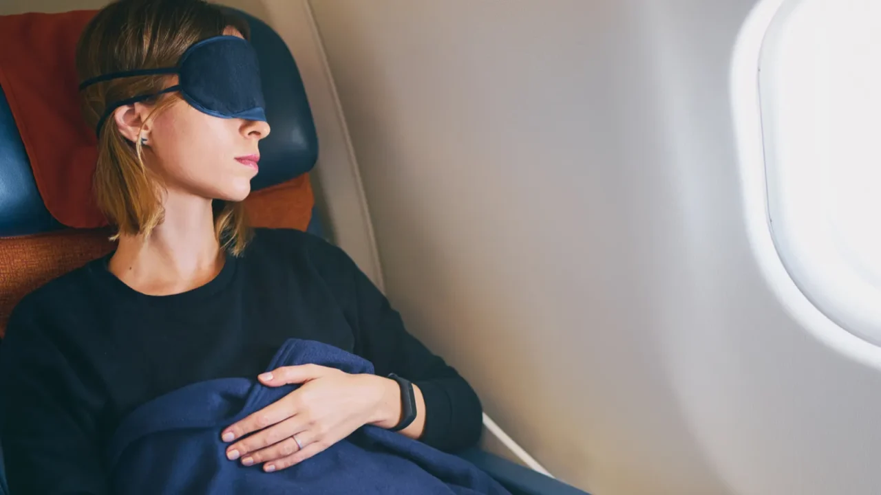 pretty young woman sleeping in airplane