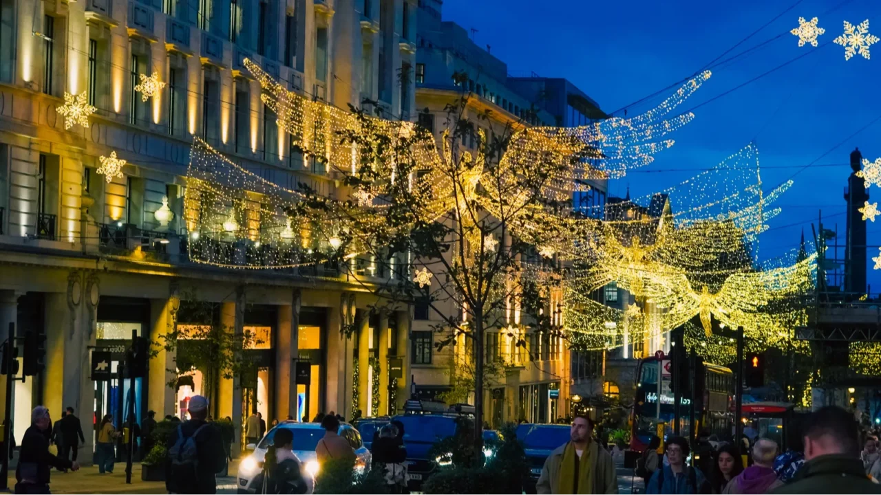 regent street glowing with golden christmas garlands during winter nights
