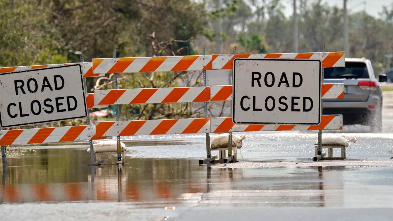 road closed for roadworks and danger of flooding with warning