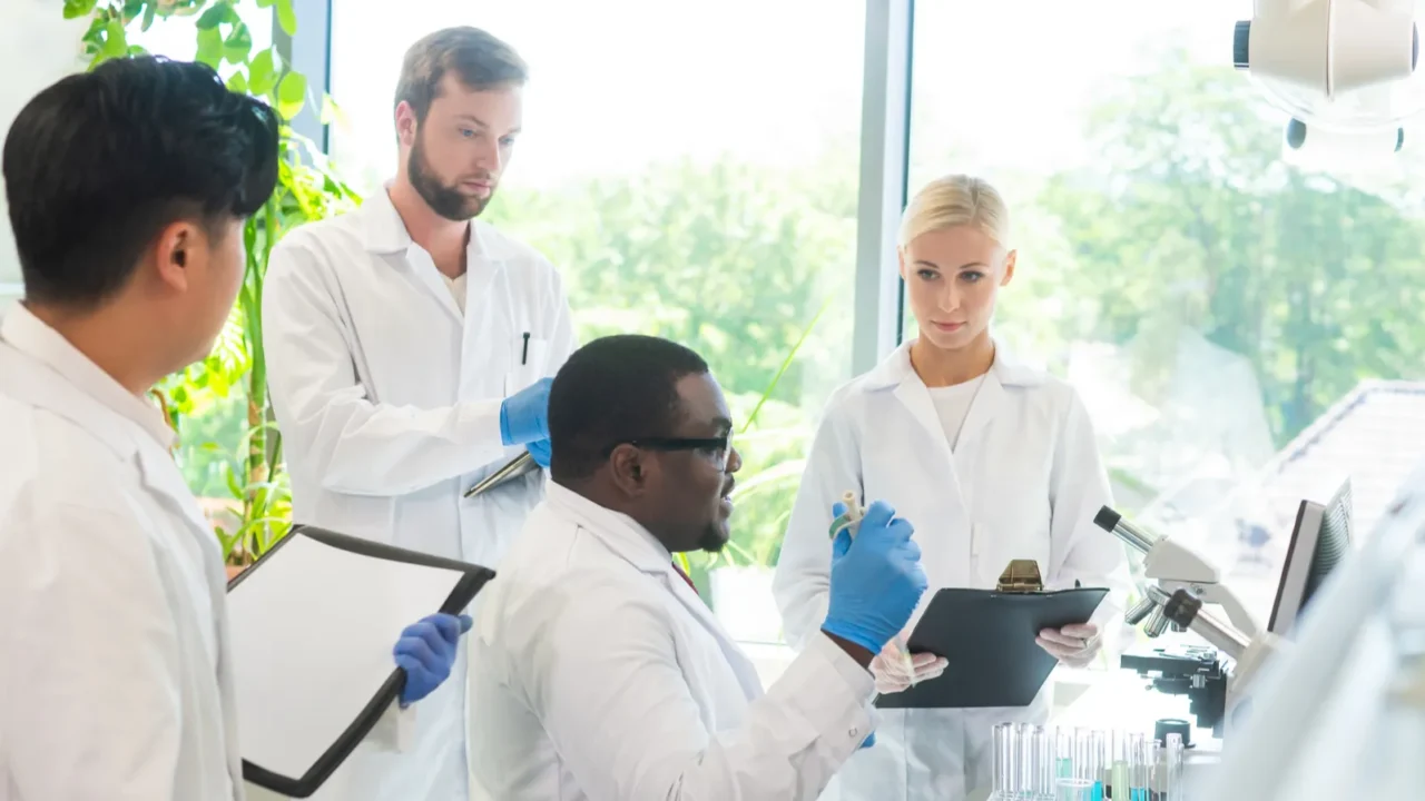 scientist and students working in lab doctor teaching interns to