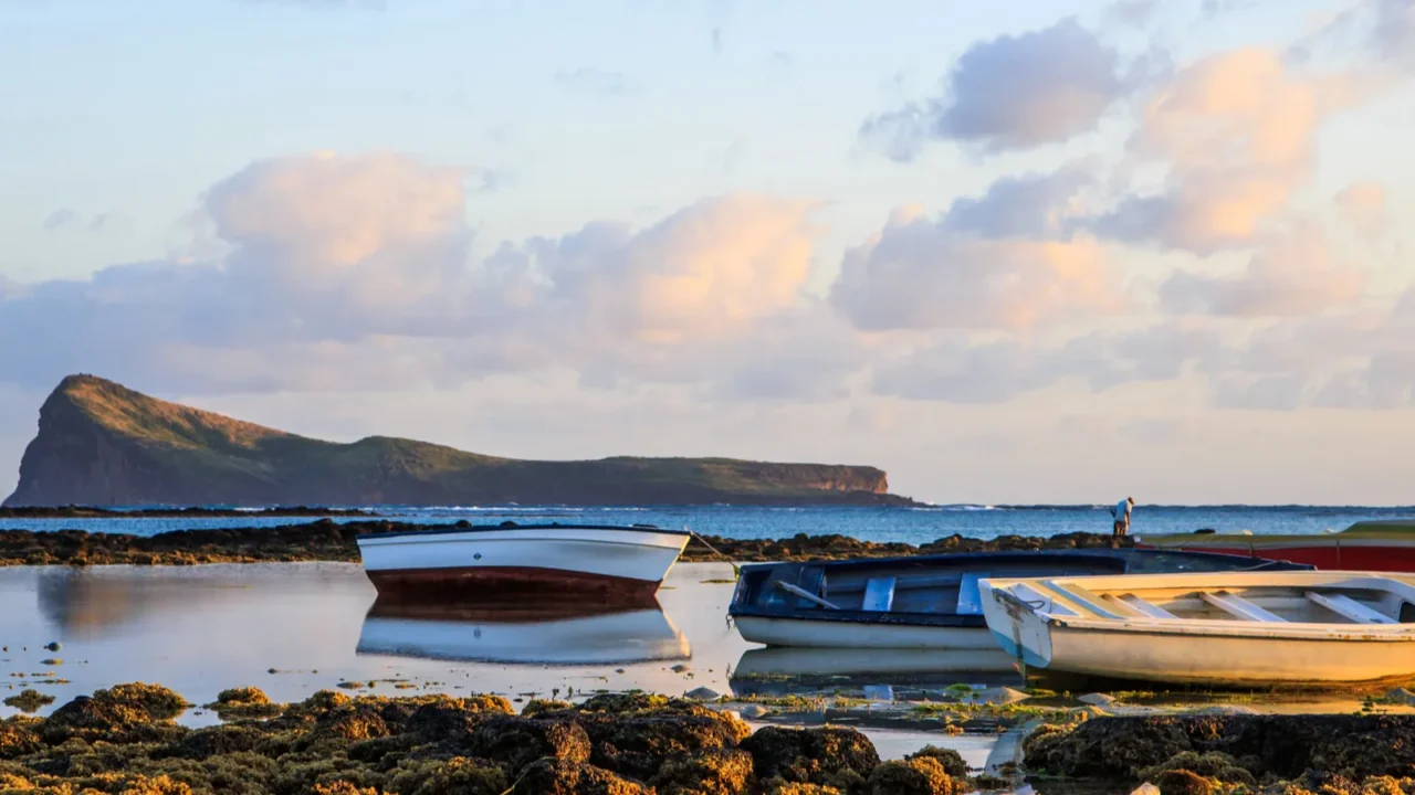 several boats docked by the coast of mauritius during sunrise