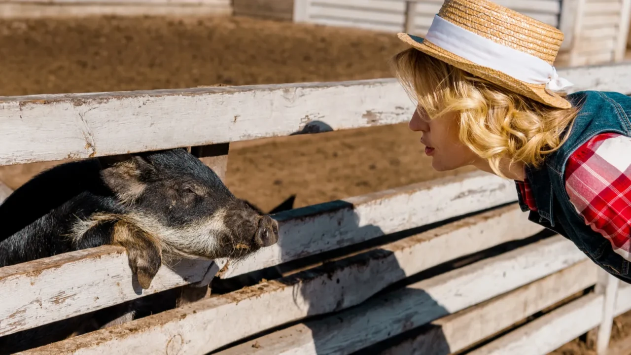 side view of woman in straw hat looking at black