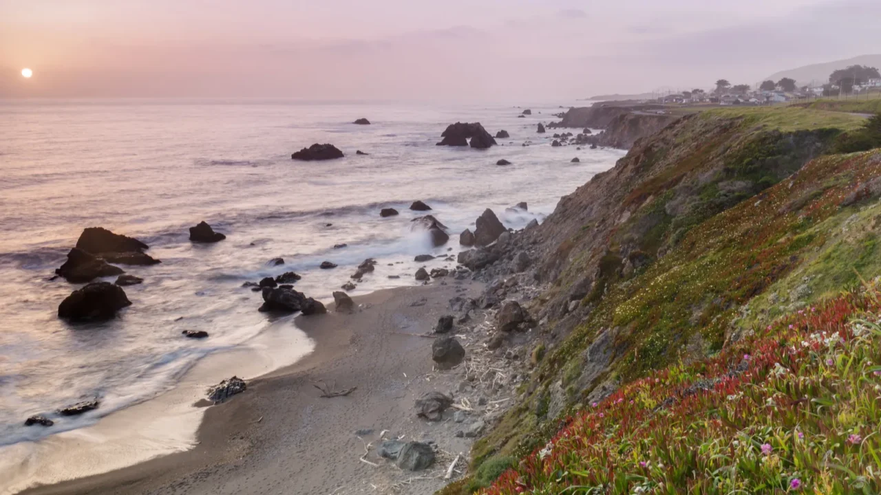 sunset over arched rock beach near bodega bay sonoma coast