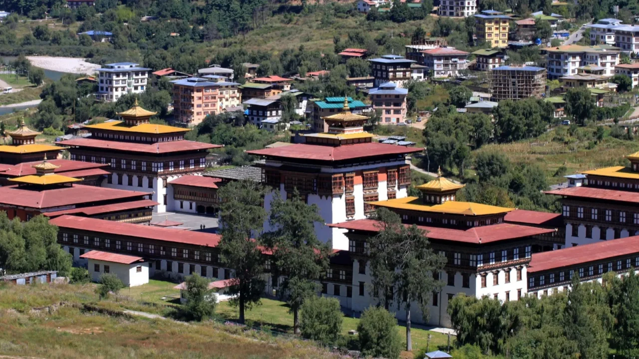 the dechencholing palace in bhutan on a sunny day