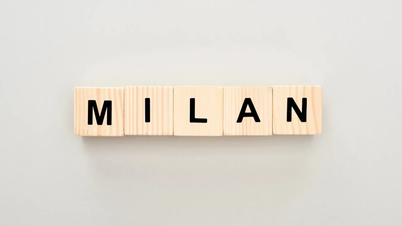 top view of wooden blocks with milan lettering on white
