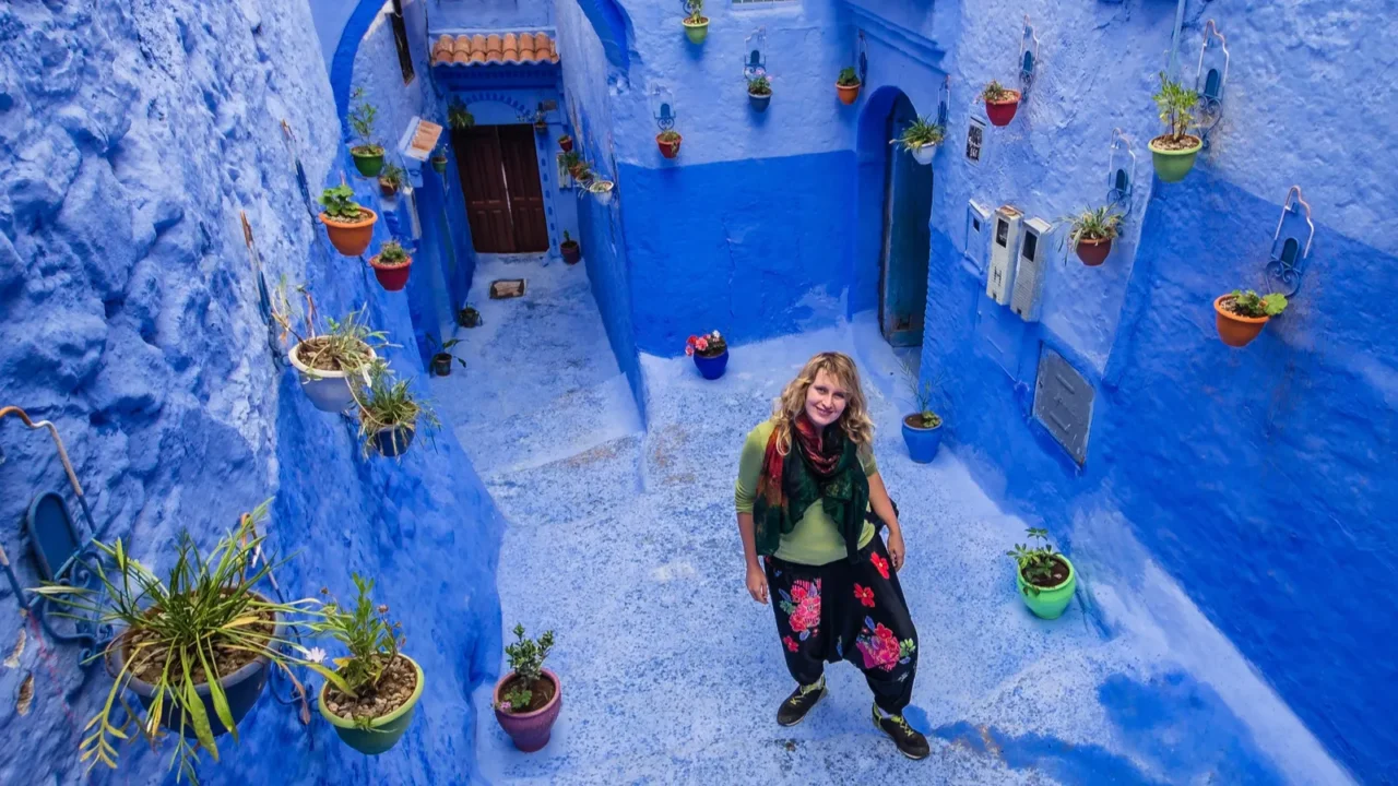 tourist seatting on the blue streets of chefchaouen morocco