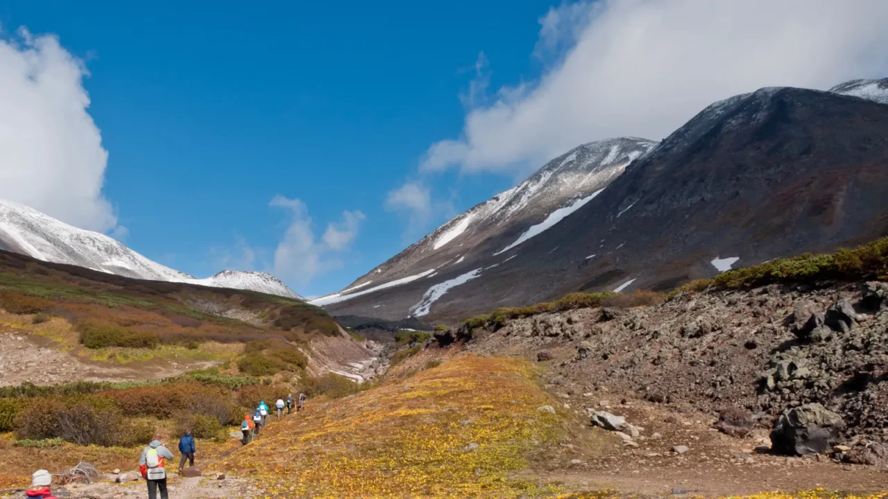 tourists hiking at dzenzur volcano nalychevo nature park kamchatka krai
