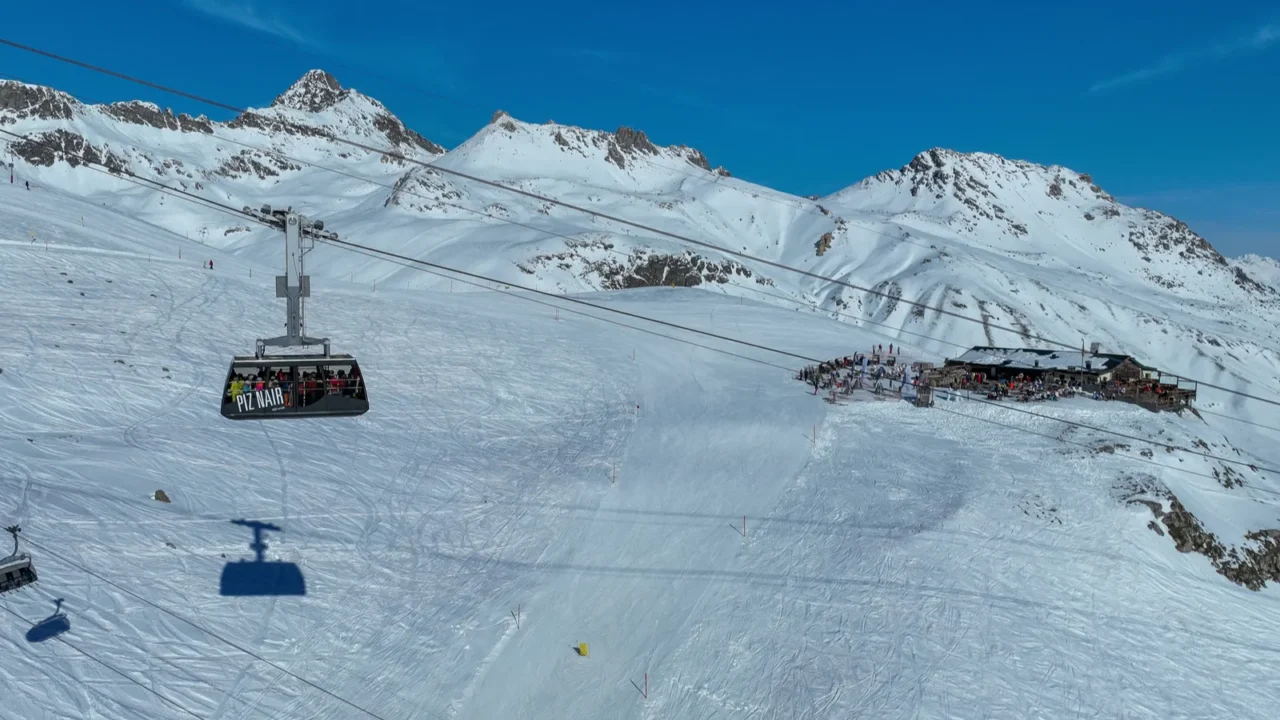 tourists riding the piz nair cable car gondola over the