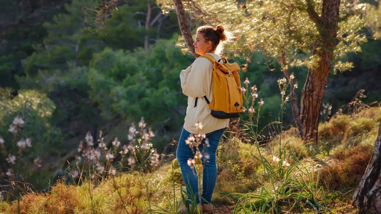travel and active lifestyle concept happy smiling woman hiking in