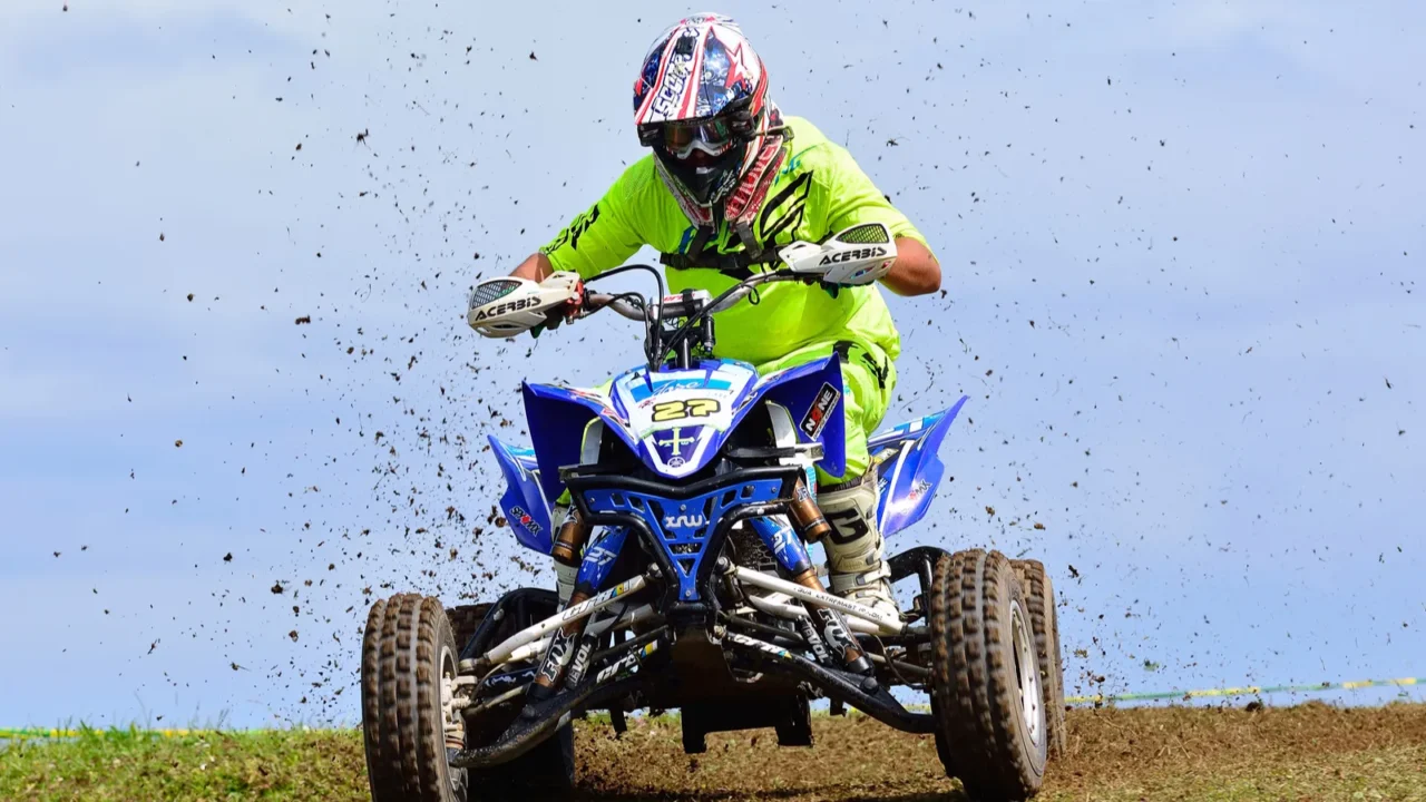unidentified racer rides a quad motorbike