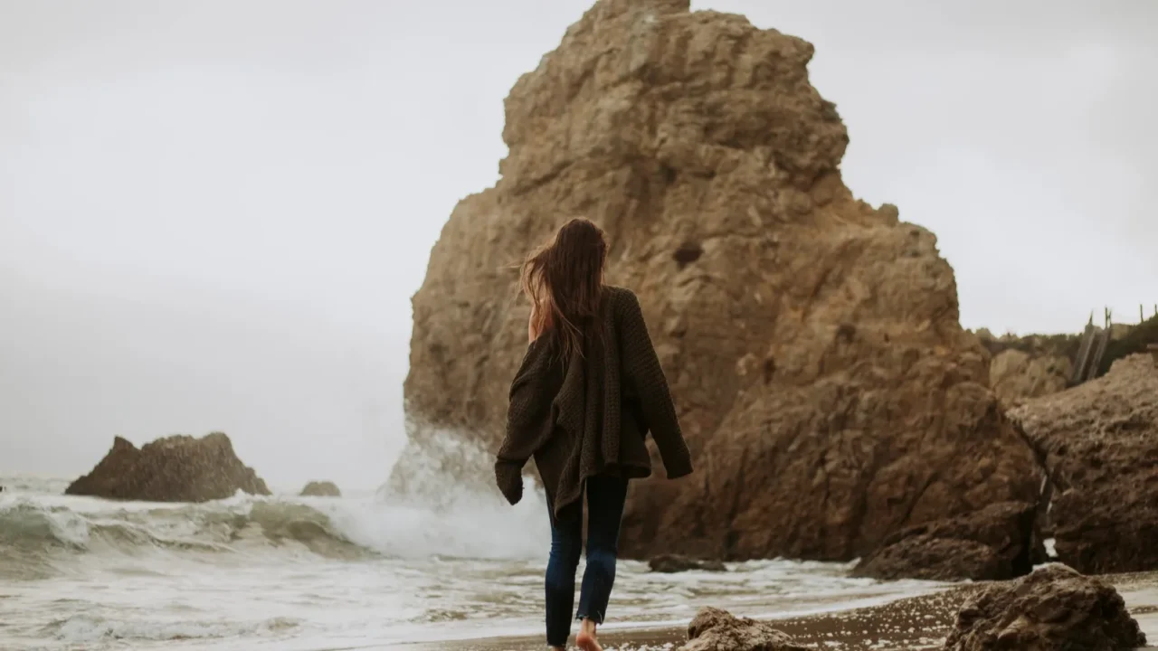 woman walking barefoot at the beach