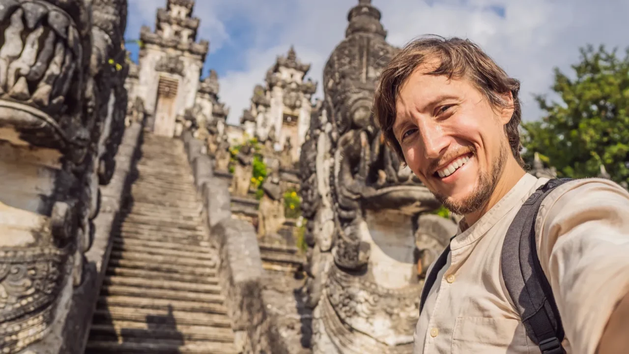 young man tourist on background ofthree stone ladders in beautiful