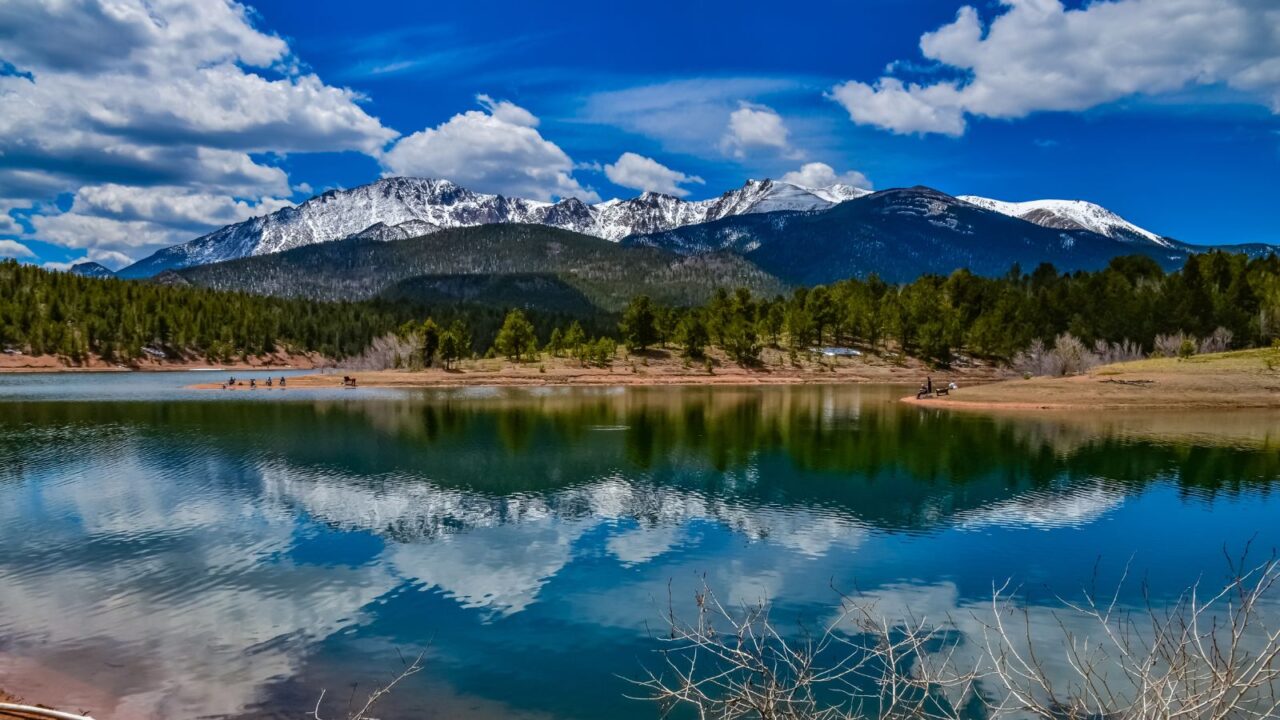 Pikes Peak panorama. Snow-capped and forested mountains near a mountain lake, Pikes Peak Mountains in Colorado Spring, Colorado, USA.