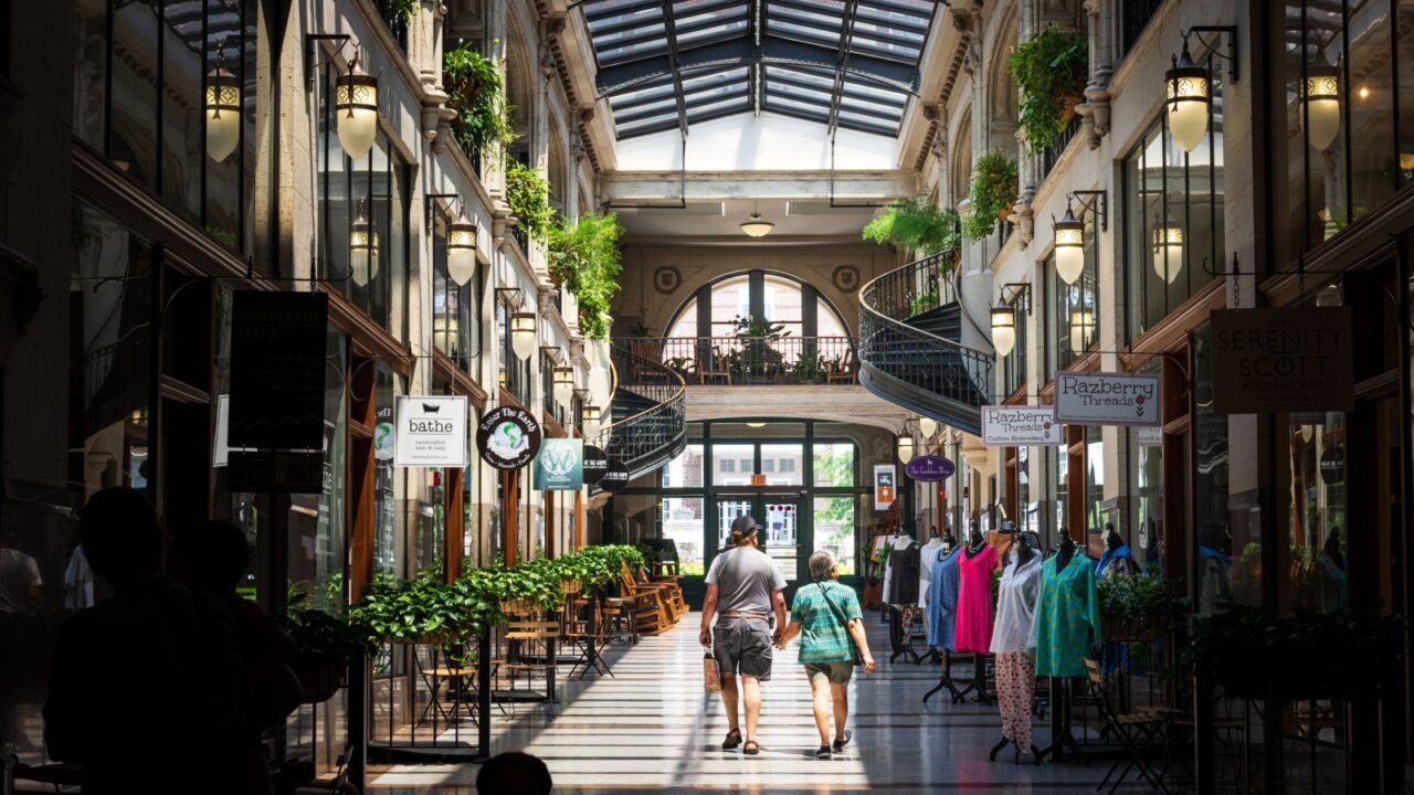 ASHEVILLE, NC, USA-10 JUNE 2018: A hallway inside the Grove Arcade, featuring a variety of small shops.