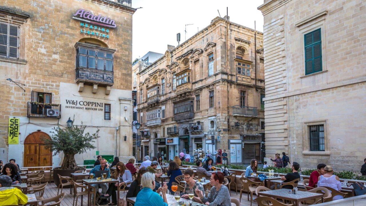 Valletta, Malta - May 22nd 2018 - Tourists having lunch in a open air restaurant inside the old town of Valletta, capital of Malta
