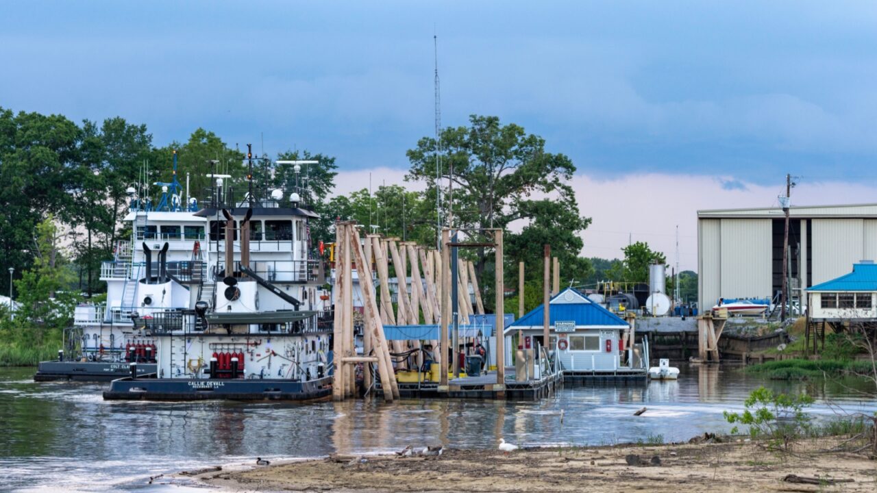 Demopolis, Alabama/USA-June 5, 2020: Barges docked at the Demopolis Yacht Basin on the Tombigbee River.