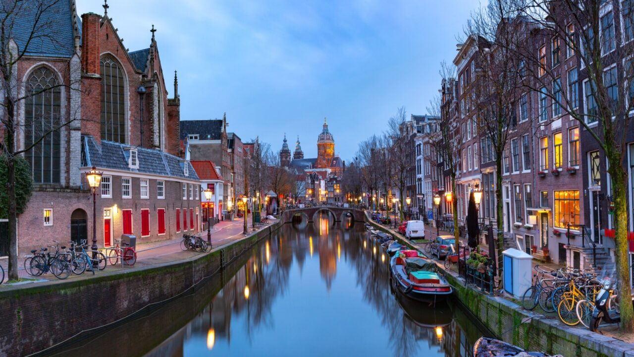 Panorama of canal in De Wallen, famous red-light district in the twilight, Amsterdam, Holland, Netherlands.