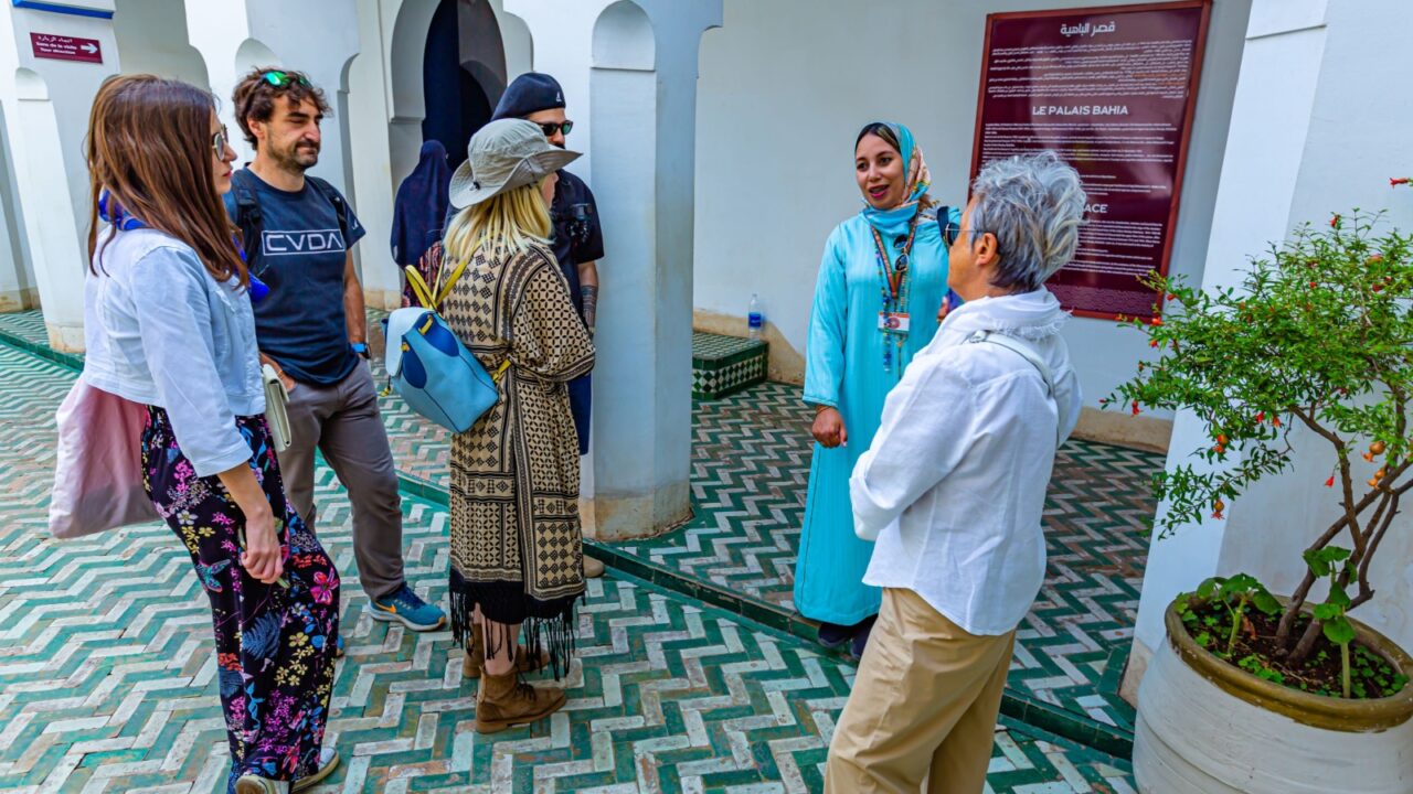 Marrakech,Marocco 18 May 2023:Tour guide explains to tourists about Marrakech in Le Palais Bahia