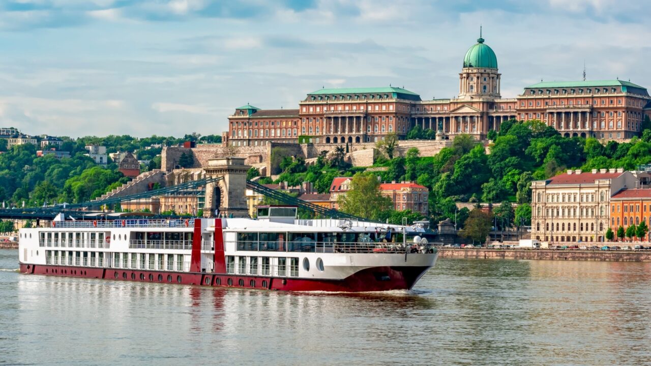 Cruise ship on Danube river with Royal palace at background, Budapest, Hungary