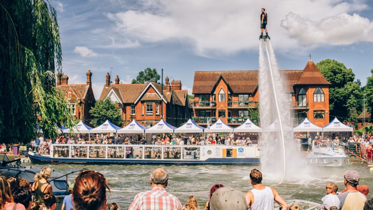 UNITED KINGDOM, BEDFORD - JULY 17, 2016: The River Festival in Bedford, people watching when participant of the show is presenting the fancy sport called flyboarding