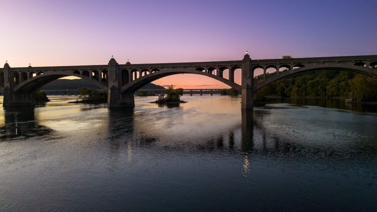 Gracefully spanning the Susquehanna River, the Columbia–Wrightsville Bridge blends historic charm and architectural beauty, its grand arches glowing at sunset in timeless cinematic splendor.