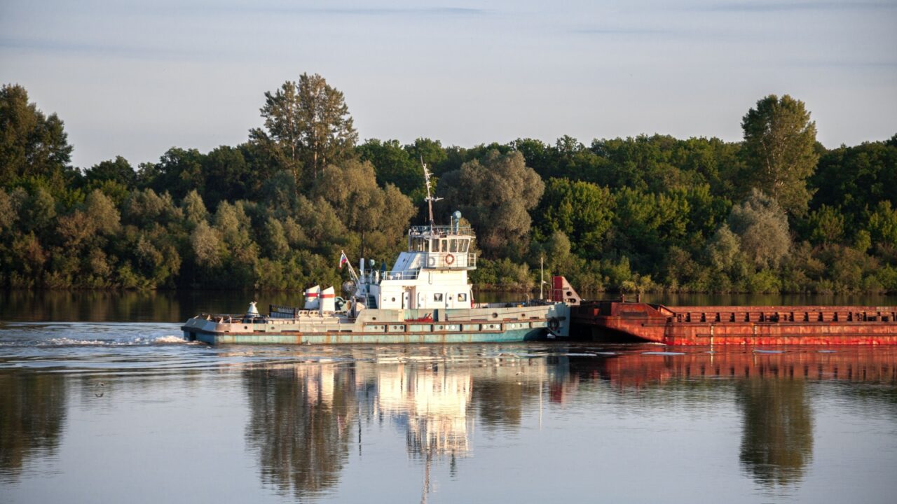 The ship transports cargo by sea, water. River cargo ship. Container ships in import export. to the commercial port, Cargo delivery to the port, International transportation