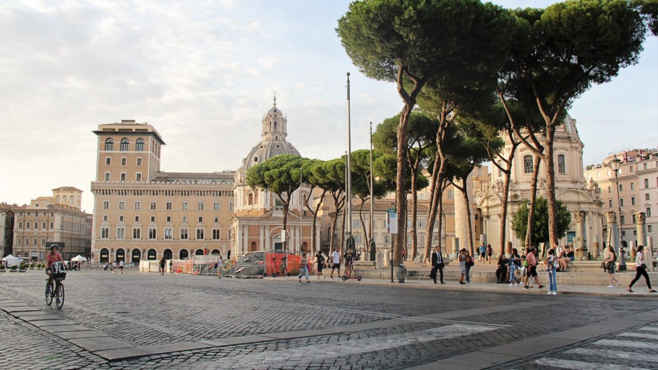 Rome, Italy -Roman City Panorama View with Via dei Fori Imperiali Road, Trajan's Forum and Walking Tourists in Rome, Italy