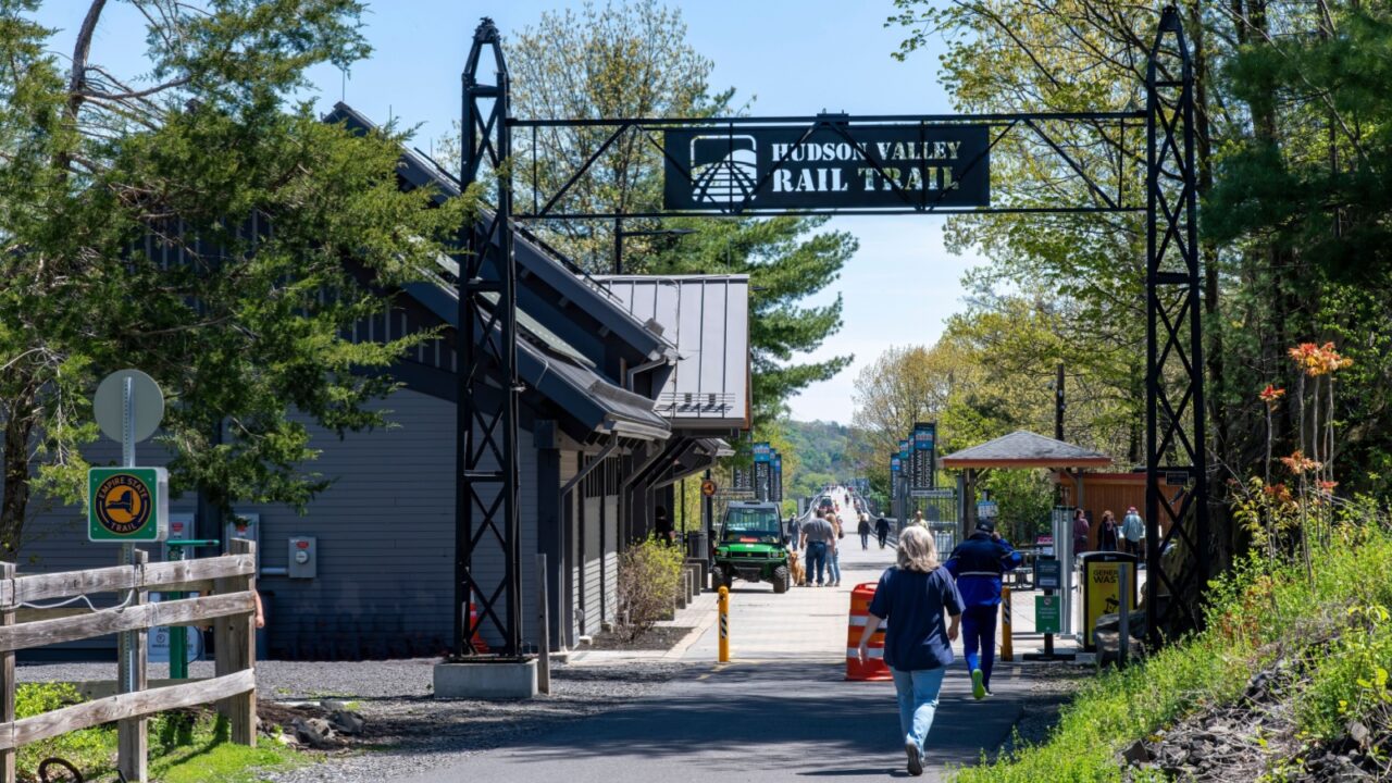 Poughkeepsie, NY, USA-May 2022; View entrance gate for the 1.28 miles Walkway Over the Hudson State Historic Park Bridge from 1889, part of the Hudson Valley Rail Trail