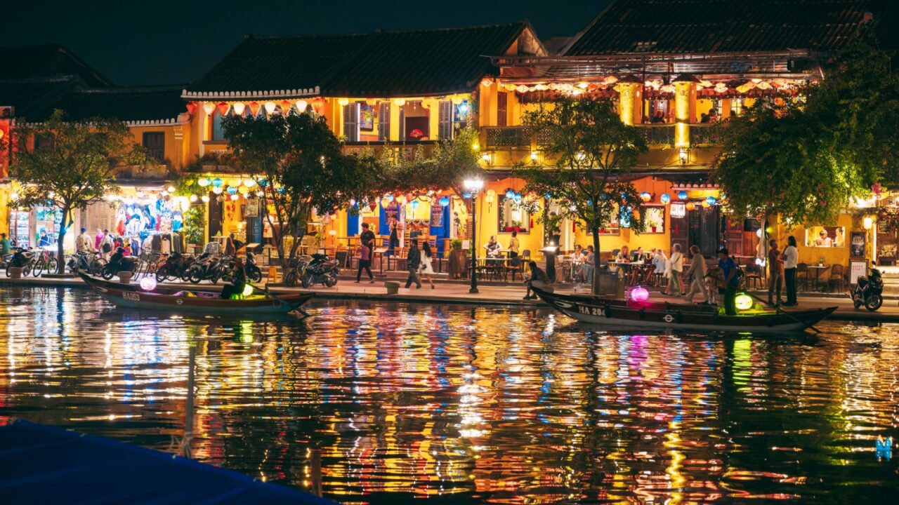 Hoi An ancient town and passenger boats on Thu Bon River at the night. Vietnam, Hoi An - December 1, 2024