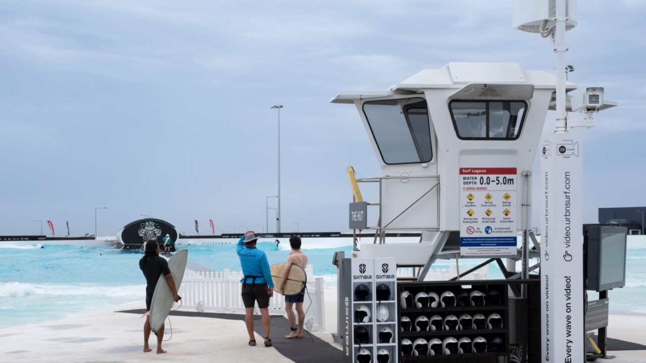 MELBOURNE, AUSTRALIA - MARCH 05 2024: Surfers get directions at Urbnsurf, a commercial urban surf park near Melbourne Airport in Tullamarine. Watchtower for lifeguards with cameras