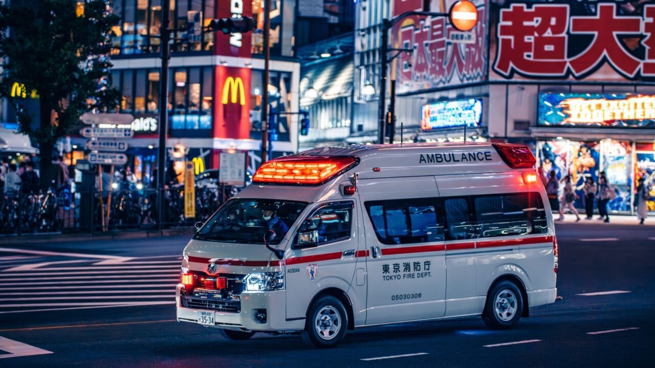 Tokyo, Japan - 05.24.2023: Japanese Ambulance speeding down the street with siren rush to rescue operation.