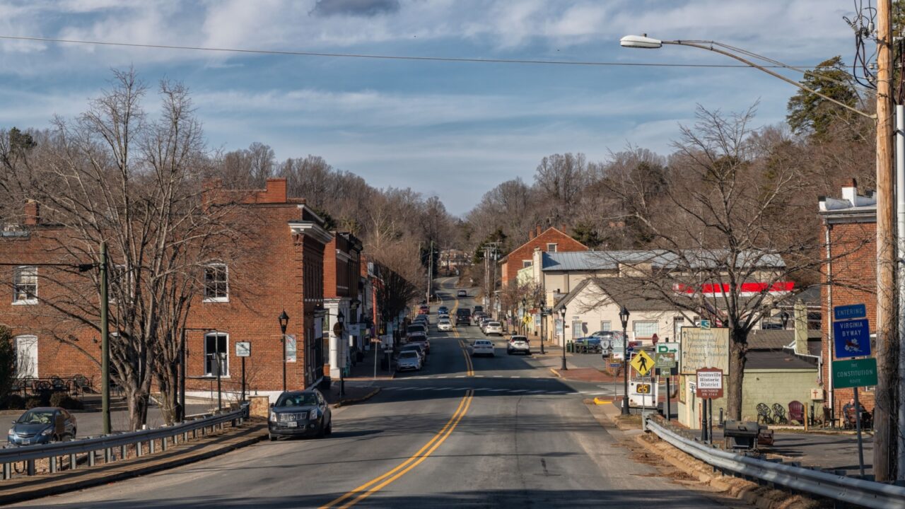 Scottsville, USA - January 26, 2025: Virginia downtown rural countryside small town with cars on road rural town city with red brick architecture