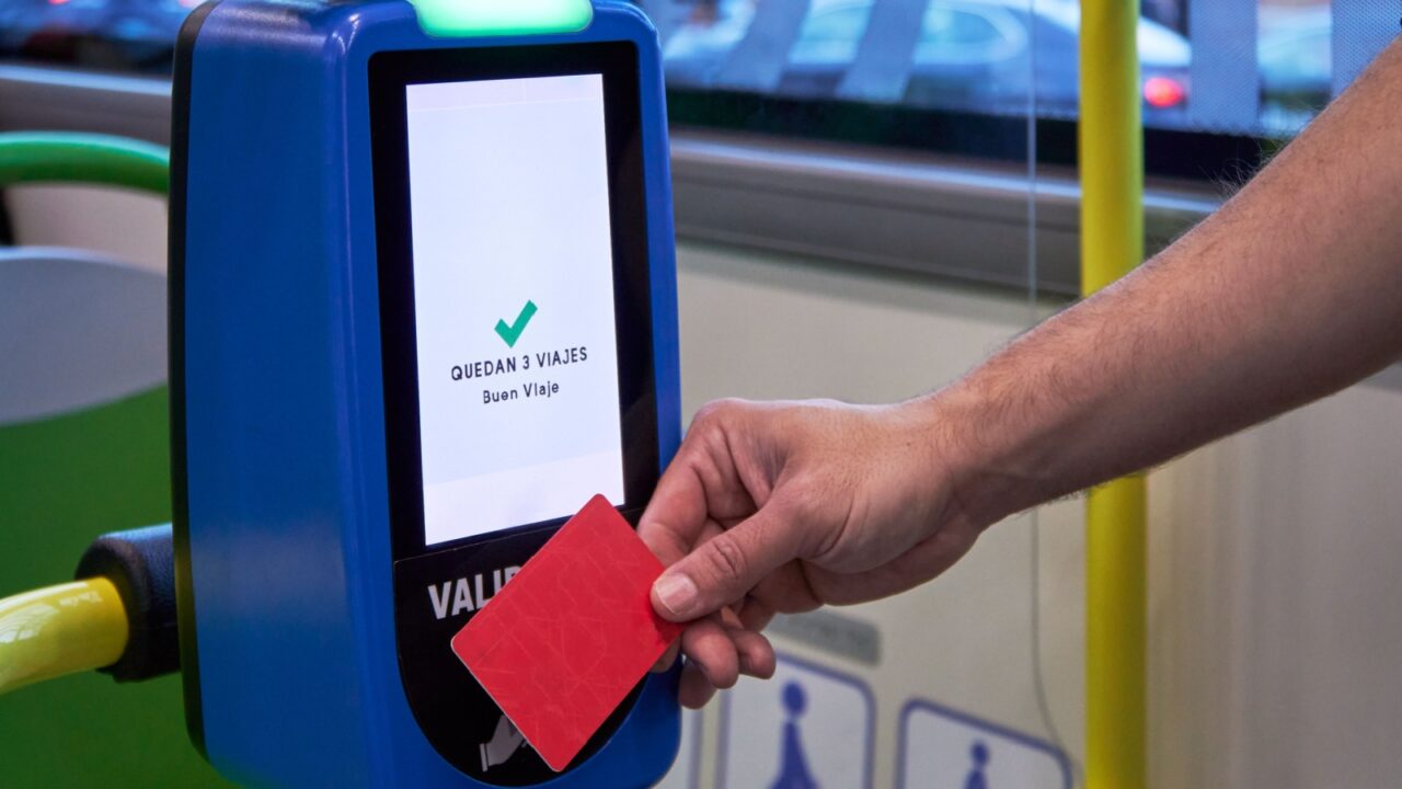 Passenger using magnetic contactless cardto pay the public bus ticket at city downtown