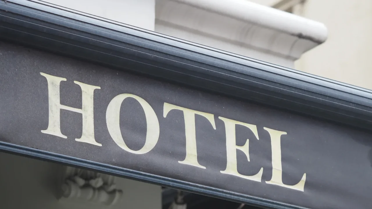 a large signage displays the word hotel in a busy