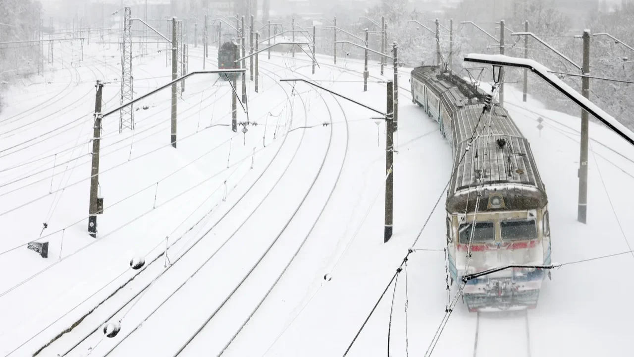 a long train of passenger cars is moving along the