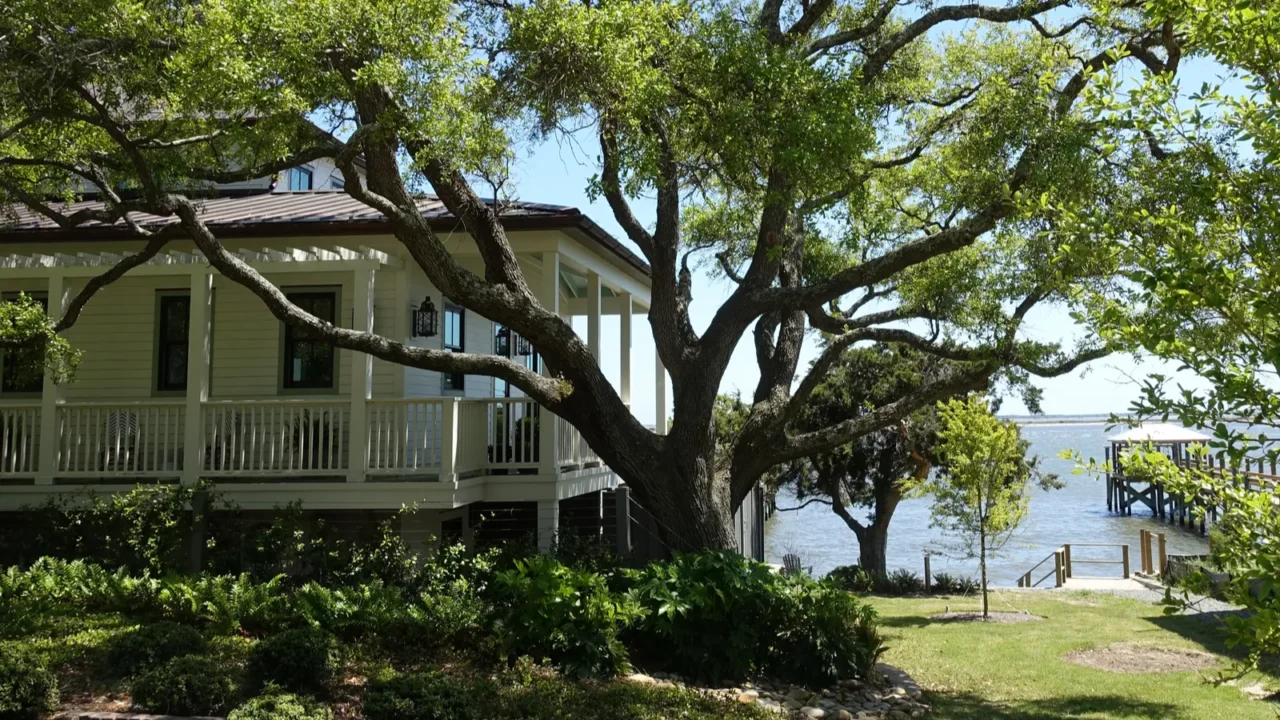 a peak of the ocean between homes in a southport
