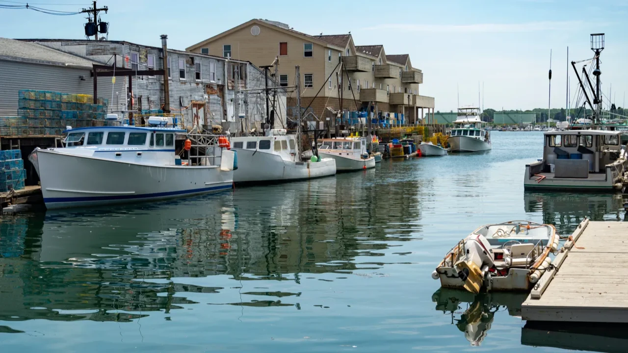 a pier filled with lobster traps and an old building