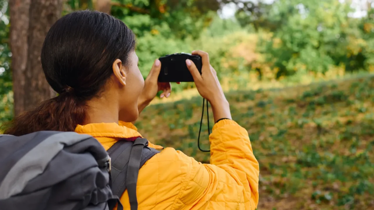 a young african american woman with a backpack takes a