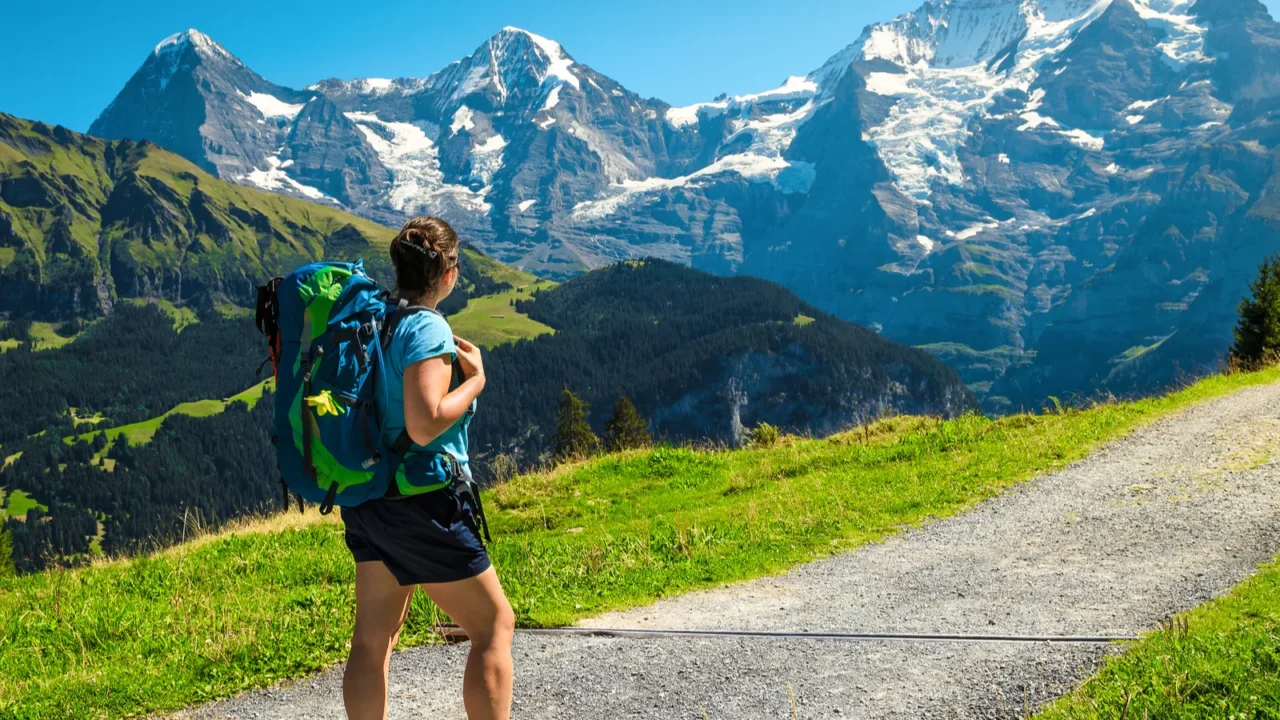 active hiker woman with backpack enjoying the view murren switzerland