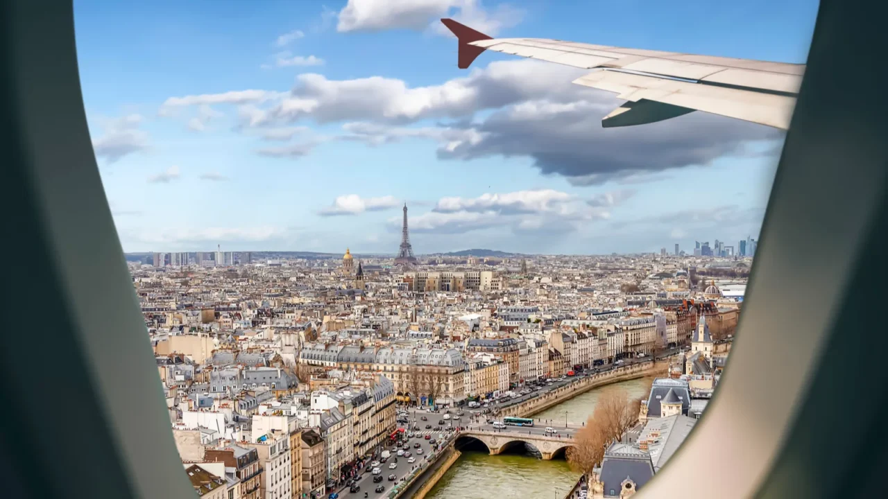 aerial view paris cityscape through airplane window while approaching to