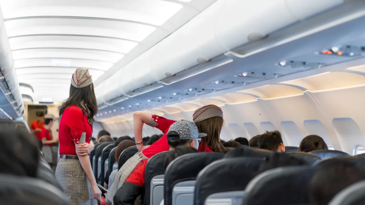 air hostess in red uniform services and checks for all