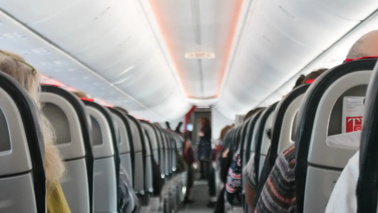 airplane cabin aisle with rear view and seats