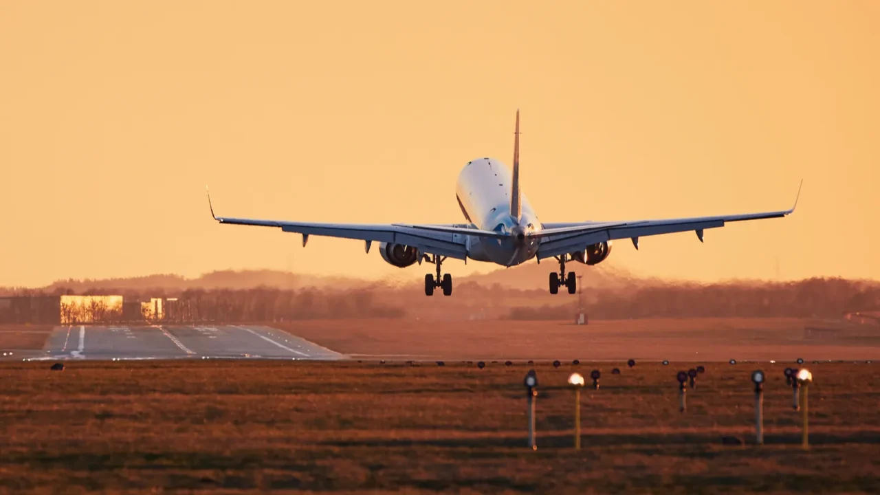 airplane landing at sunset
