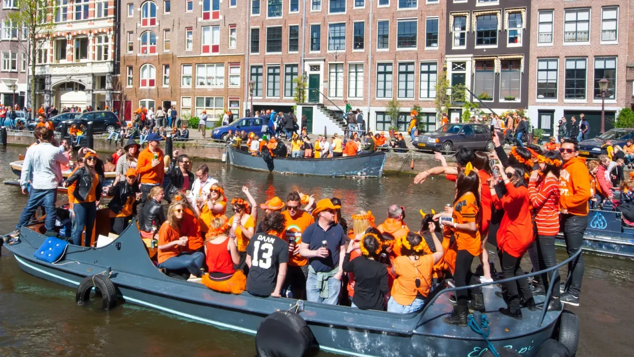 amsterdamapril 27 locals on the boats participate in celebrating kings