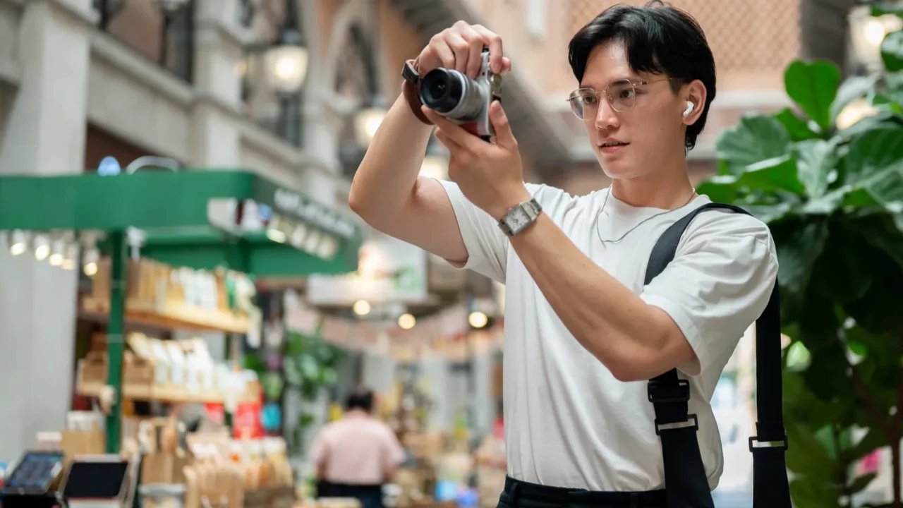 asian man wearing glasses in white tee is taking a