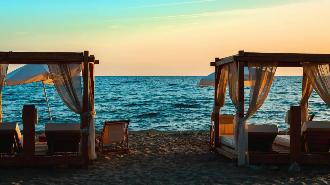 beach cabana beds and sun loungers on the seashore at