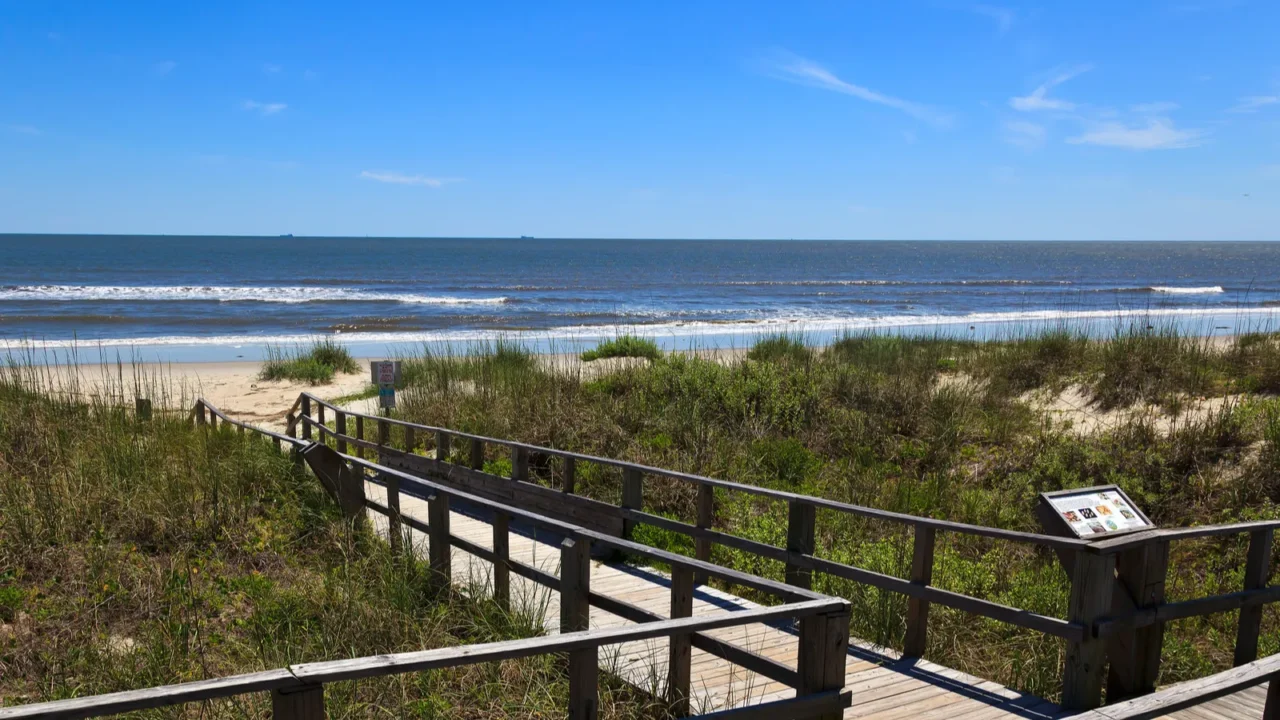 boardwalk leading to caswell beach in north carolina